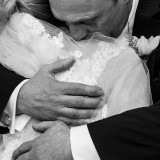 black and white closeup of bride hugging father